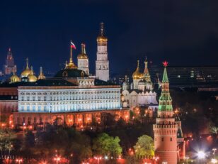 a large building with towers and a flag on top